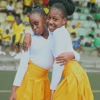 Two students smiling in their sports day outfits